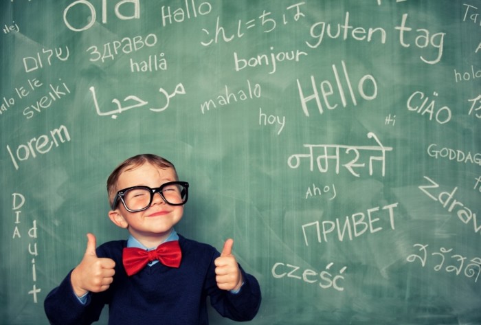 Child at chalkboard with languages